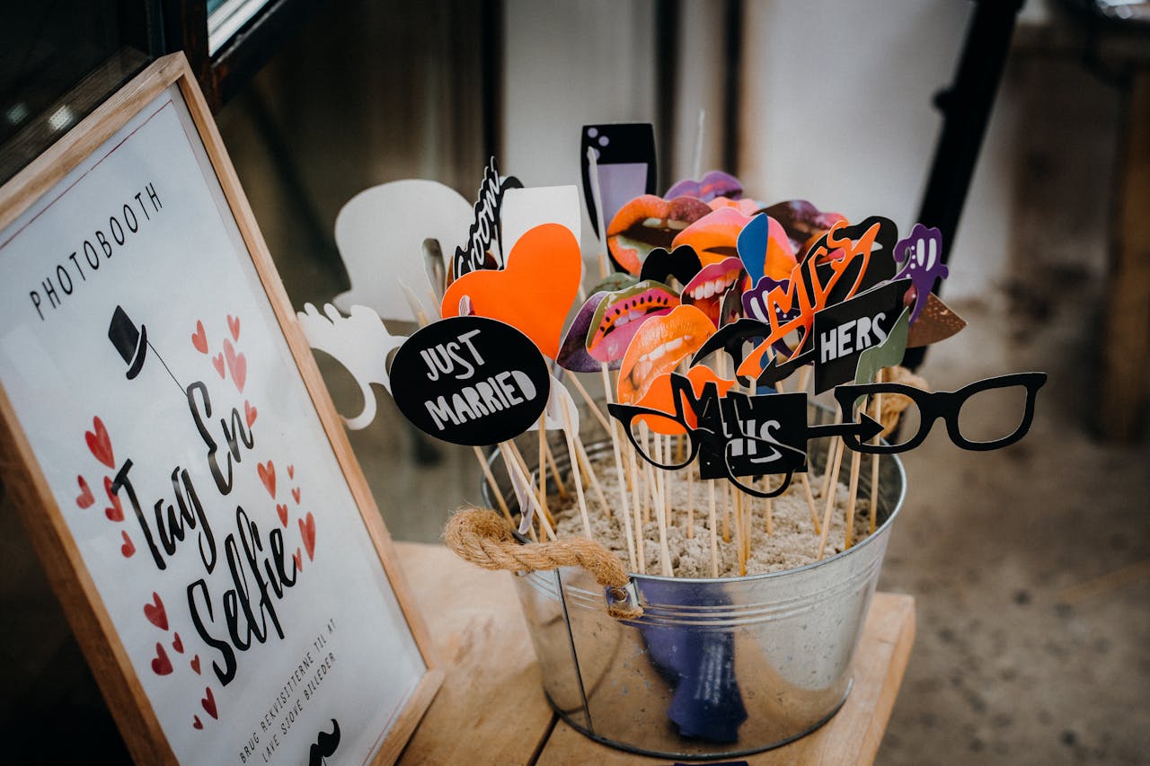 Creative wedding photobooth props with fun designs like glasses and moustaches.